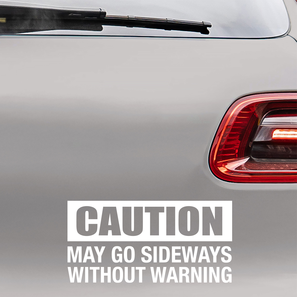 Bilstickers med teksten "Caution, may go sideways without warning"