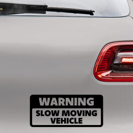 Bilsticker med teksten "Warning, slow moving vehicle"